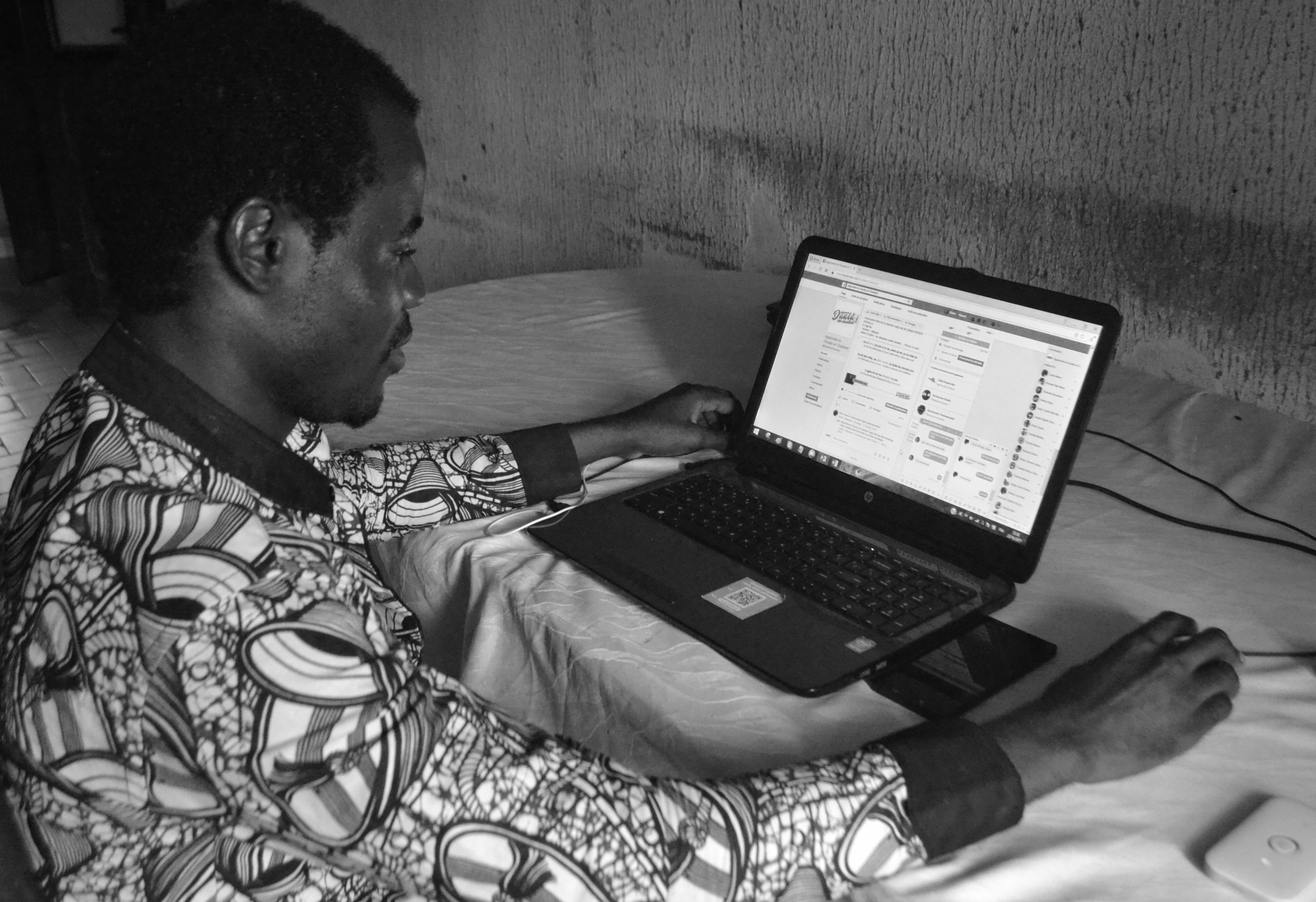 African in a office with a laptop