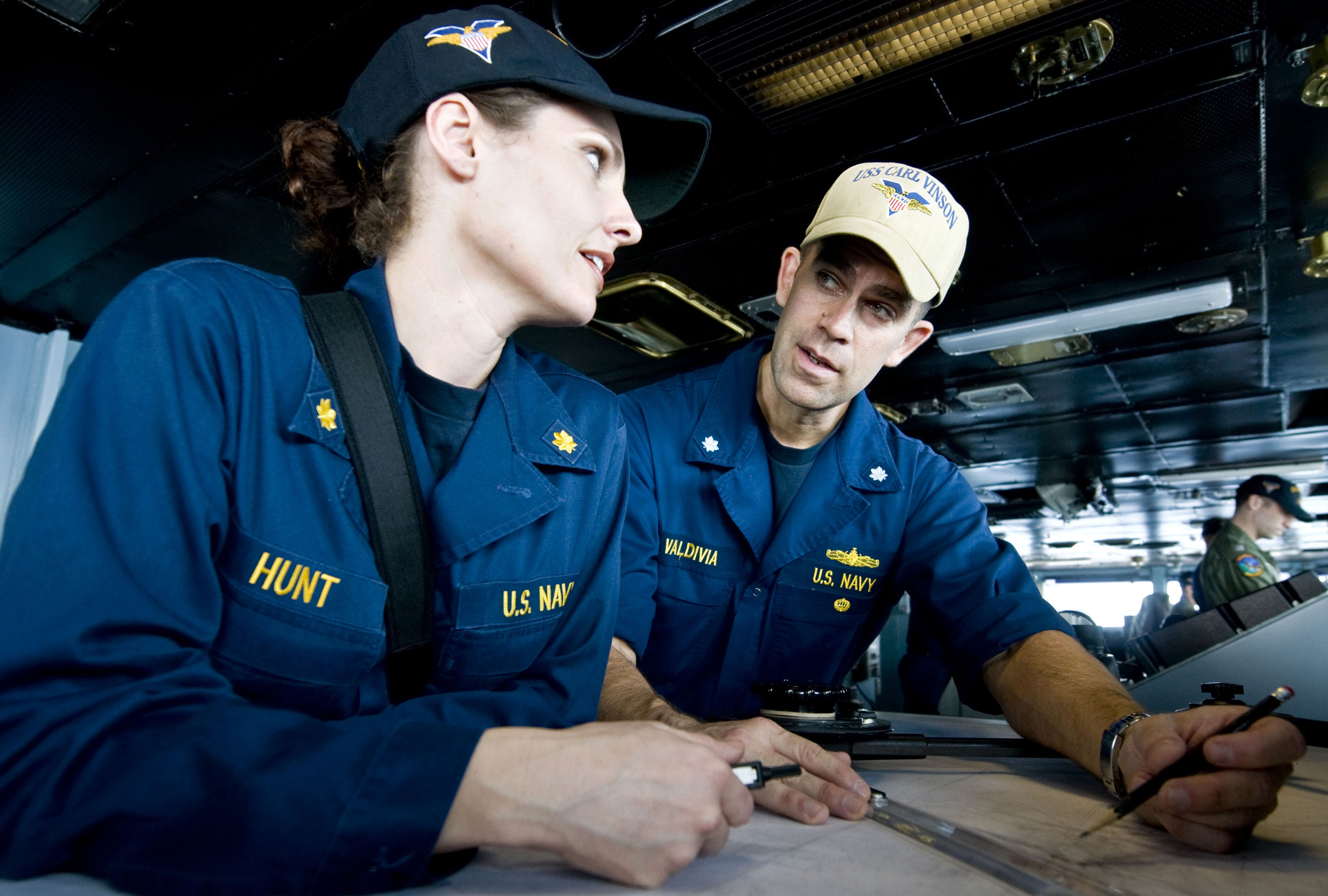 Defense.gov News Photo 110412-N-6320L-085 - Cmdr. Christopher Valdivia auxiliaries officer aboard the aircraft carrier USS Carl Vinson CVN 70 explains how to plot the ship s coordinates to
