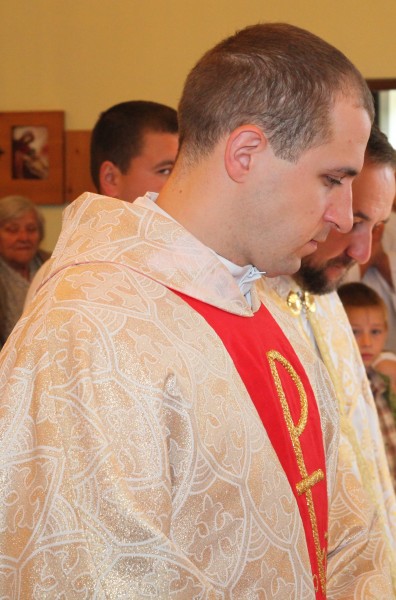 a young Catholic priest in a Church, photo 1