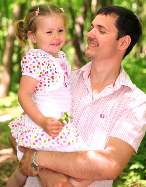 a handsome Catholic father holding his cute daughter in May 2013