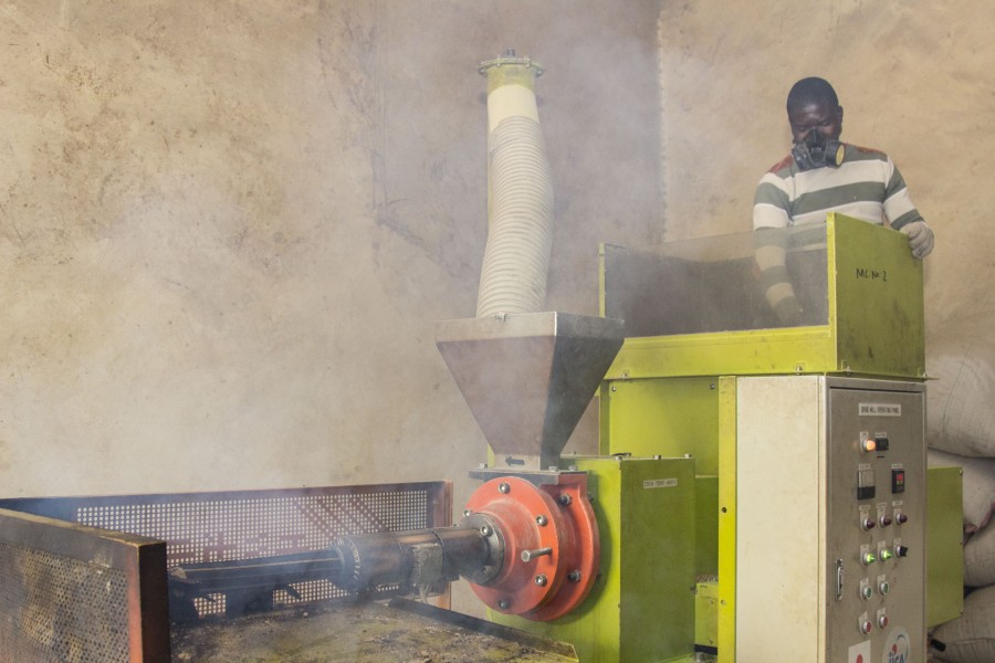 A man making woodfire by rice residue