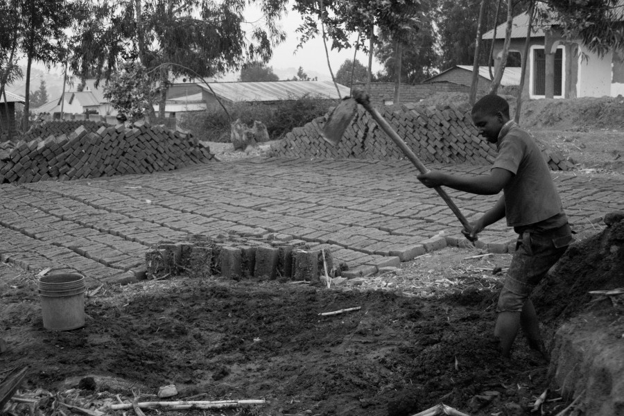 A man preparing mud for making blocks