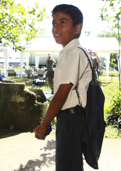A student smiles after receiving a backpack filled with school supplies Aug. 25, 2010, at Hone Creek School in Hone Creek, Costa Rica 100825-M-PC721-034