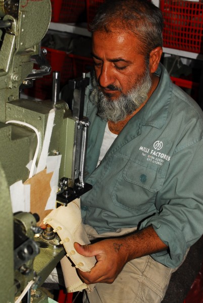A worker at the Kabul Melli factory handcrafts combat boots (4919575166)
