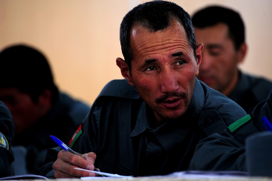 Afghan National Police trainee Nazem Hosain takes notes during a radio communications lesson at Regional Training Center, Bamyan