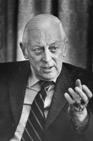 Alistair Cooke, head-and-shoulders portrait, facing front, gesturing with left hand, during interview, March 18, 1974