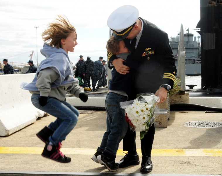 Children express their excitement as they welcome home their father from a six-month deployment of the Los Angeles-class attack submarine USS Norfolk (SSN 714) at Naval Station Norfolk, Va., on Nov 121103-N-EP471-023
