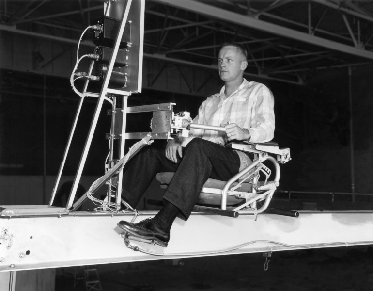 Closeup of research pilot Neil Armstrong operating the Iron Cross Attitude Simulator reaction controls