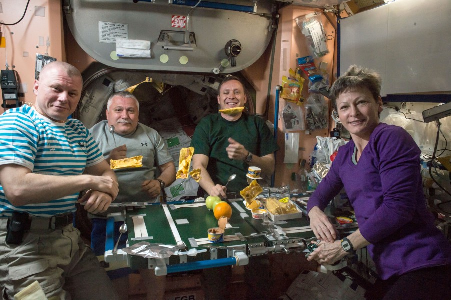 ISS-51 crew members share a meal inside the Unity module