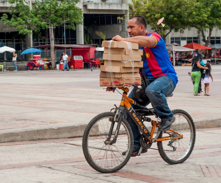 Man carrying boxes on a bicycle