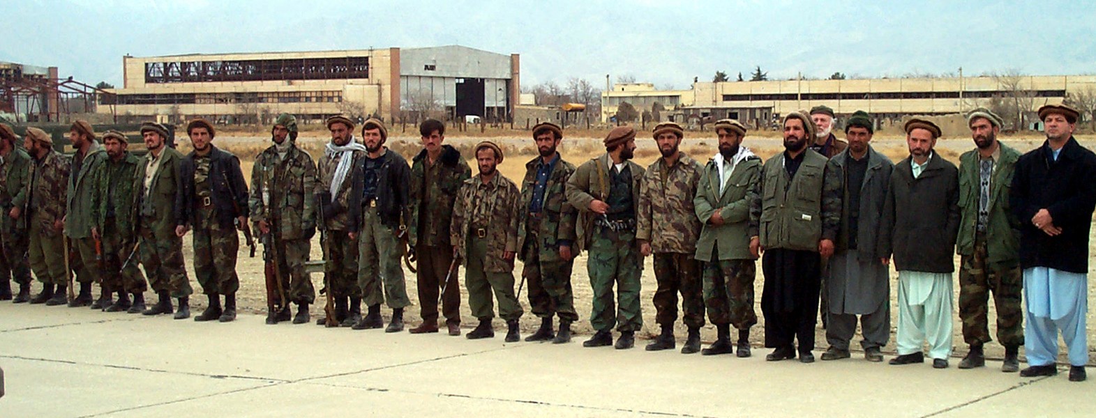 Northern Alliance troops line a runway at Bagram Airbase