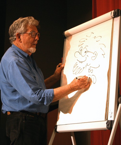 Rolf Harris drawing a self-portrait