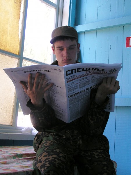 Russian soldier reading newspaper
