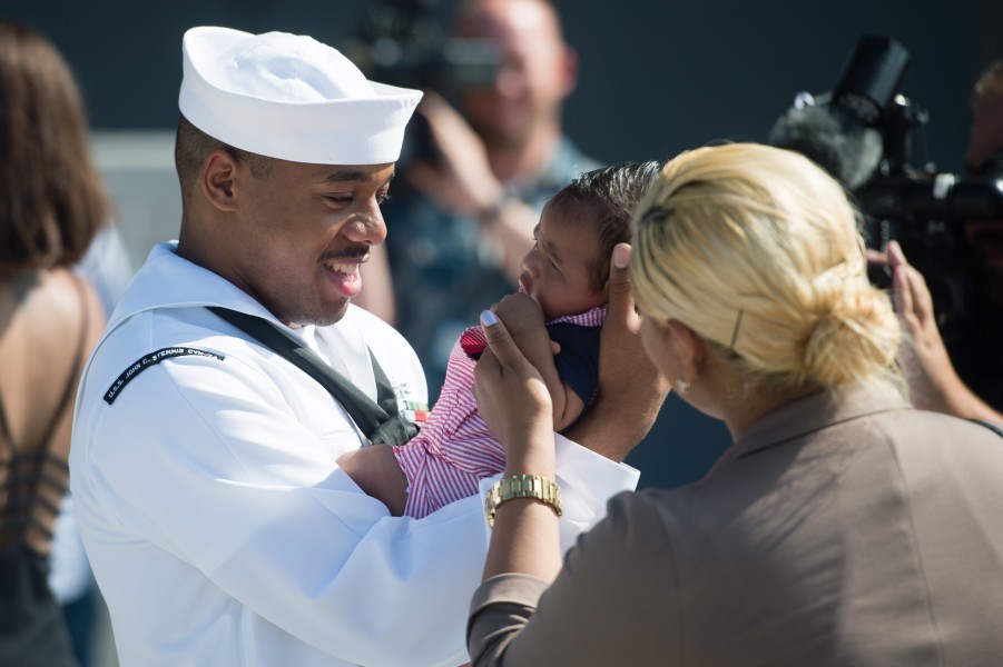 Sailor meets his child for the first time after returning from a seven-month deployment