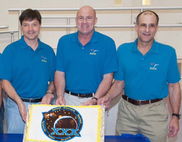 Soyuz TMA-03M crew during a cake-cutting ceremony
