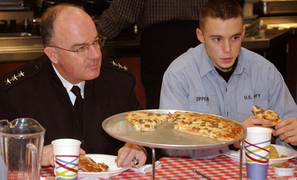 U.S. Navy Vice Adm. John C. Harvey Jr., (left), Chief of Naval Personnel, shares a pizza with Seaman Recruit Kolby Zipperer during Pizza Night at the Recruit Training Command (RTC), Great Lakes, Ill., on Jan 080110-N-IK959-007