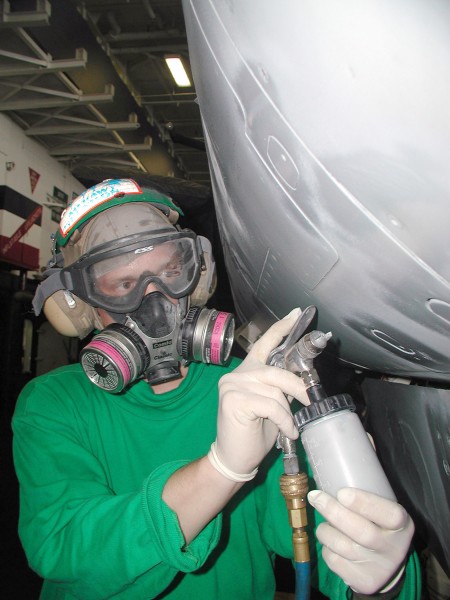 US Navy 021211-N-1356A-001 Aviation Ordnanceman 1st Class Robert Glendon from Callicoon, NY. assigned to Fighter Squadron Two (VF-2) touches up the paint on the nose of a F-14 ^ldquo,Tomcat.^rdquo