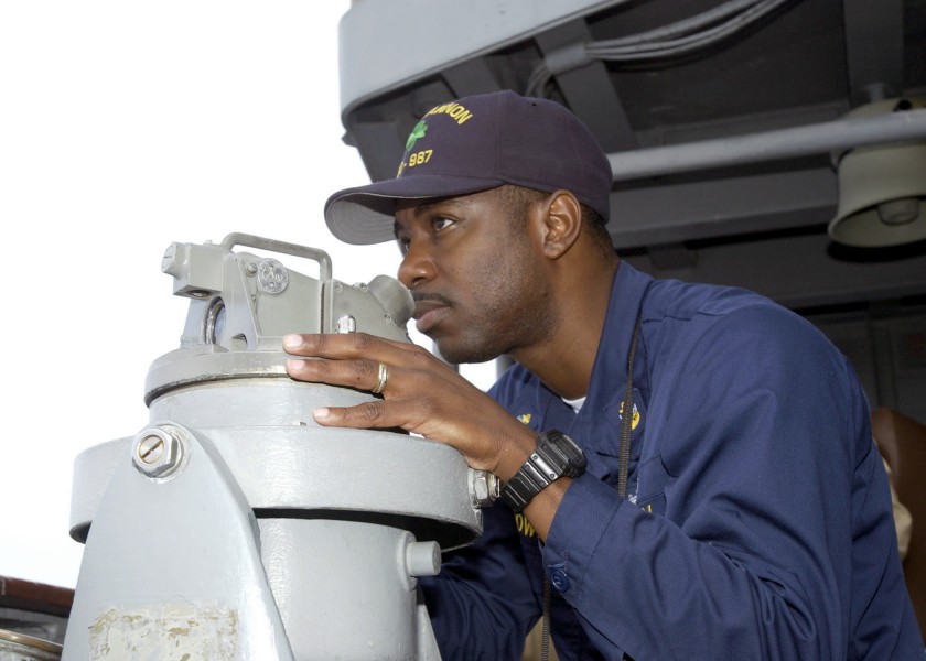 US Navy 030221-N-4649C-003 Chief Yeoman Duane Gowins from Melbourne, Fla., determines other ships' bearings using a telescopic alidade