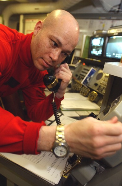 US Navy 030425-N-4953E-031 Aviation Ordnanceman 3rd Class Vincent Dunhill-Cooper calls the forward bomb assembly area using the 5JG1 Sound Power Phone System