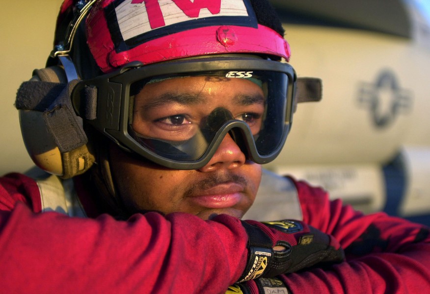 US Navy 030805-N-6213R-220 Aviation Ordnanceman 3rd Class Demetrius Moore, of Philadelphia, Pa., watches the sun set over the Pacific Ocean during a break in flight operations while aboard USS John C. Stennis (CVN 74)