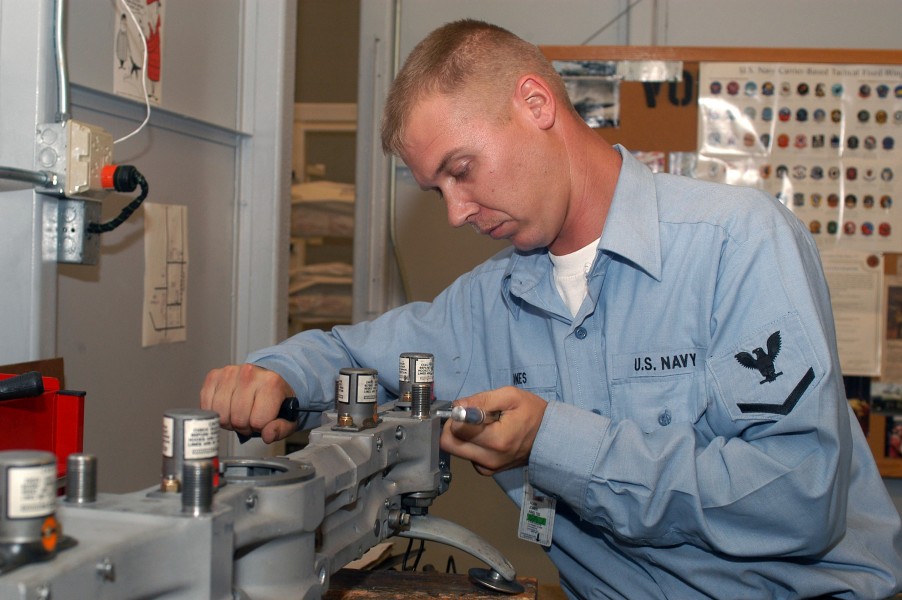US Navy 031007-N-8770A-001 Aviation Ordnanceman 3rd Class Michael Jones assembles a bomb rack