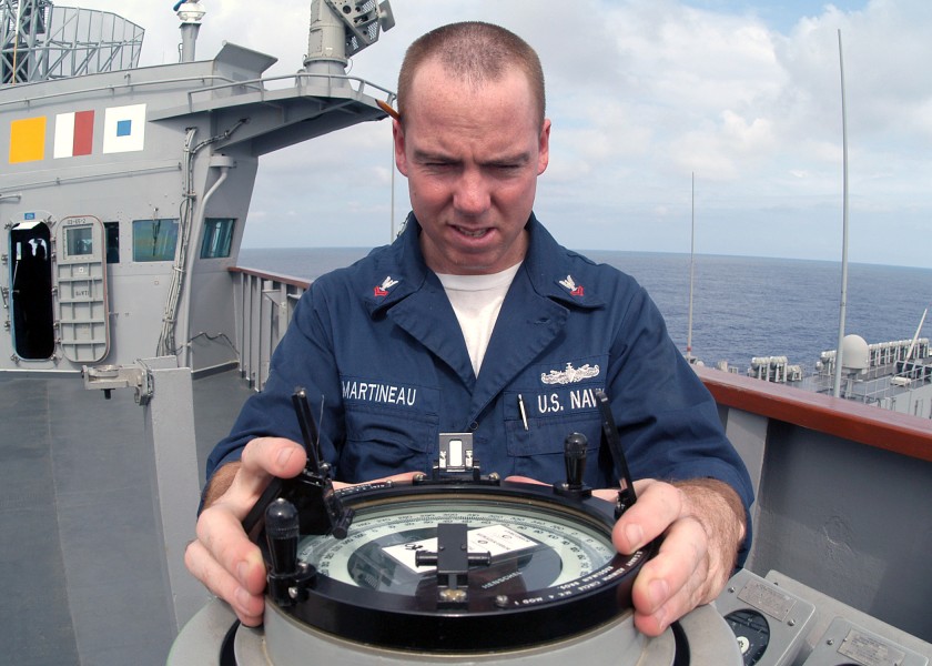US Navy 031103-N-8955H-005 Quartermaster 2nd Class Greg Martineau, from Ft. Lauderdale, Fla., uses an Azimuth Circle to read the bearing to the sun from the starboard bridge wing of USS Blue Ridge (LCC 19)