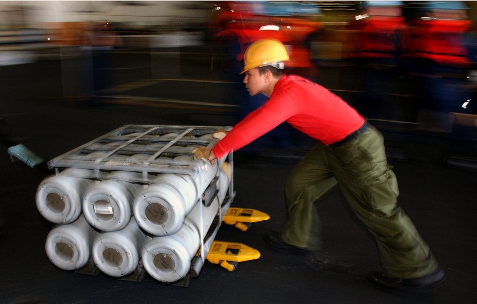 US Navy 040320-N-6213R-444 An Aviation Ordnanceman moves a pallet of BLU-111 500 lb. bombs through the hangar deck of USS John C. Stennis (CVN 74) during a vertical replenishment (VERTREP) at sea with the fast combat support sh