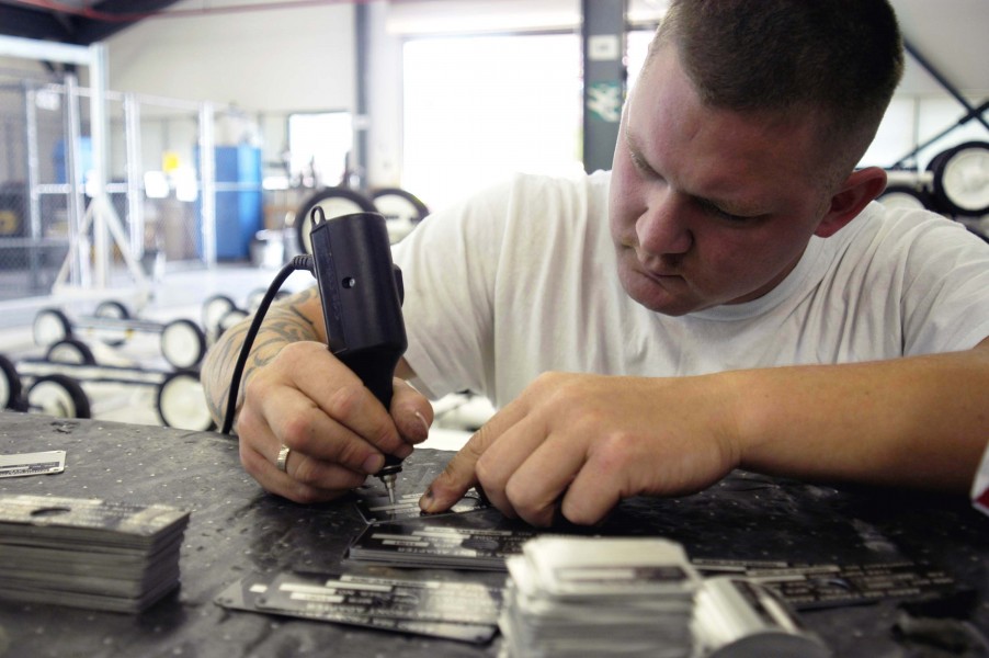 US Navy 040816-N-0683J-011 Aviation Ordnanceman 2nd Class Sam Riggle assigned to the aircraft carrier USS Carl Vinson (CVN 70), engraves identification tags for the recently constructed weapon support equipment at the Naval Sta