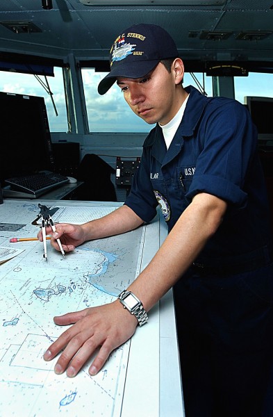 US Navy 040917-N-7232R-038 Quartermaster Seaman Maricio Auilar, of Los Angeles, Calif., plots the position of the aircraft carrier USS John C. Stennis (CVN 74) on a nautical chart during her transit through the Java Sea