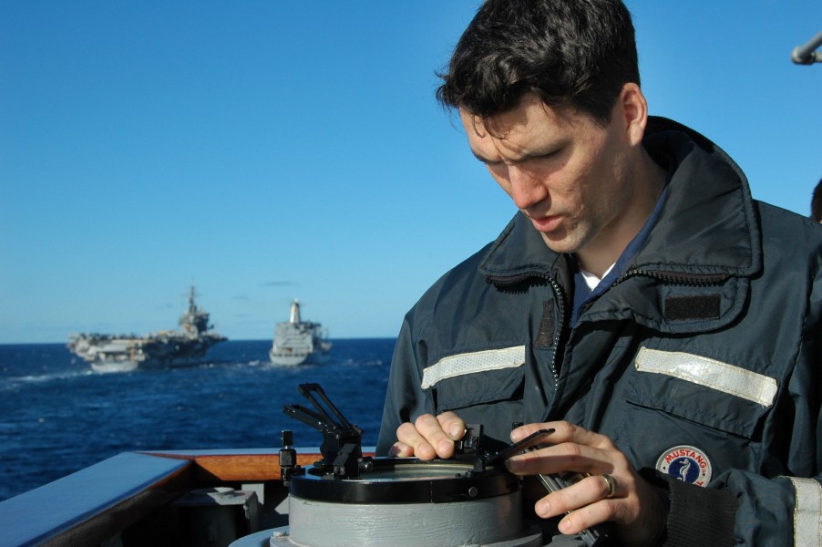 US Navy 050624-N-5781F-034 Quartermaster 2nd Class Nicholas Pavlow consults an azimuth circle aboard the guided missile cruiser USS Cowpens (CG 63) to find bearing and range before conducting a replenishment at sea (RAS) 