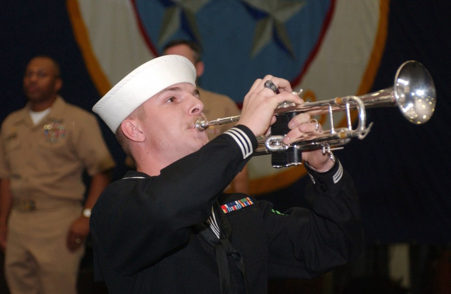 US Navy 060107-N-1416P-047 Aviation Ordnanceman Airman Timothy Lanning plays taps during a memorial ceremony for two sailors