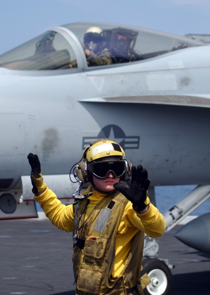 US Navy 060423-N-6484E-003 On the flight deck of the Nimitz-class aircraft carrier USS Theodore Roosevelt (CVN 71), Aviation Boatswain's Mate Handler 3rd Class Jeremy Sills looks for oncoming aircraft