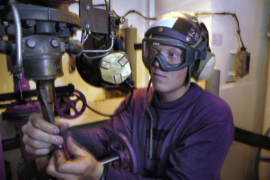 US Navy 060530-N-3946H-076 Aviation Boatswain's Mate (Fuels) Airman Joshua Hinck changes the diaphragm of the de-fueling pressure relief valve in Aviation Fuel Station 24 aboard USS Kitty Hawk (CV 63)