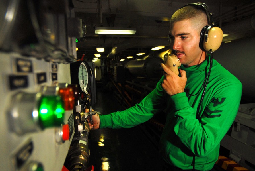 US Navy 070529-N-2659P-066 Aviation Boatswain's Mate (Equipment) 2nd Class Joseph Mikes from air department's launch and recovery division charges an arresting gear engine to recover aircraft aboard Nimitz-class aircraft carrie