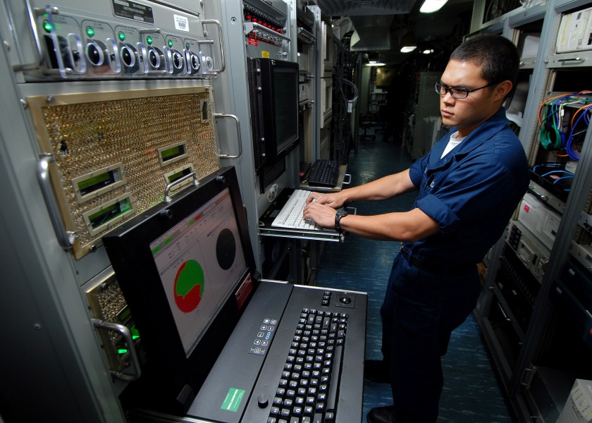US Navy 070713-N-7981E-108 Information Systems Technician Seaman Jaron Franck monitors the ship's automated digital networking system from the radio communication center aboard Nimitz-Class aircraft carrier USS Abraham Lincoln