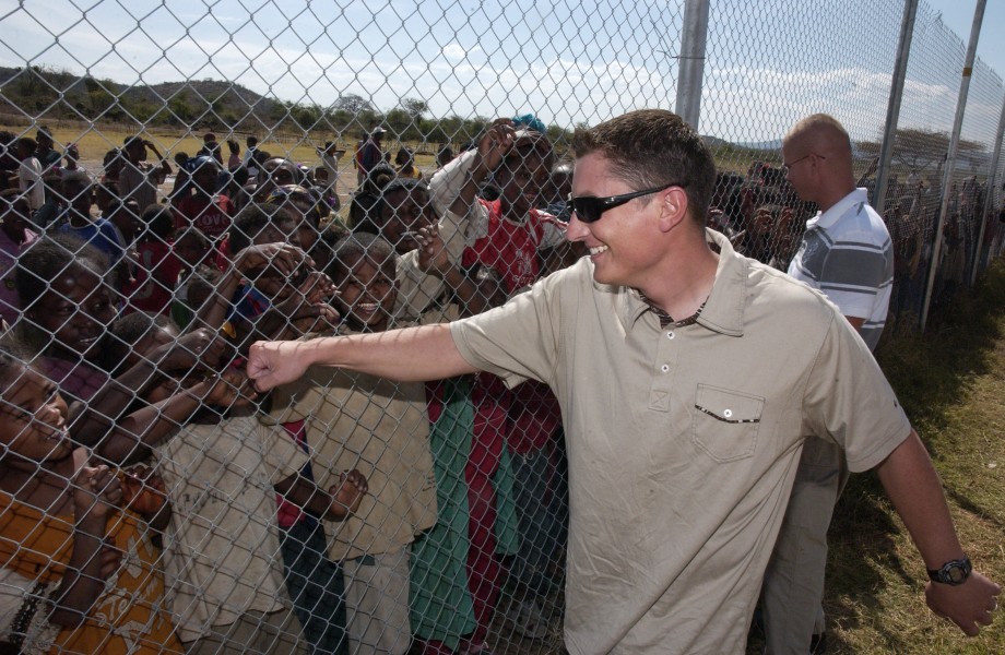 US Navy 080117-F-4089F-002 Builder 1st Class Jason Verneris greets children of the Bilate Charicho region in Ethiopia as they wait to attend the dedication of two new school buildings