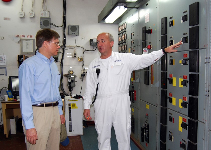 US Navy 080621-N-6387D-001 The Military Sealift Command hospital ship USNS Mercy (T-AH 19) Chief Engineer, Joseph Watts, in white, explains the inner workings of the engine room to Deputy Chief of Mission from the U.S. Embassy 