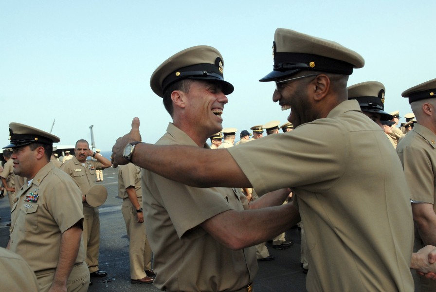 US Navy 080916-N-4005H-221 Newly pinned Chief Aviation Boatswain's Mate (Fuels) Robert Sparks is congratulated by a chief petty officer after a chief pinning ceremony aboard the aircraft carrier USS Ronald Reagan (CVN 76)