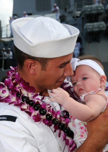 US Navy 081001-N-9758L-129 oatswain's Mate Seaman Ryan Cook hugs his daughter after the ship moors at Naval Station (NAVSTA) Pearl Harbor