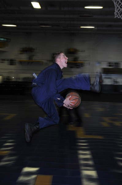 US Navy 090417-N-3027S-048 Aviation Boatswain's Mate (Handling) Airman Kyle Simpson shows off his basketball skills in the hangar bay of the aircraft carrier USS Nimitz (CVN 68)