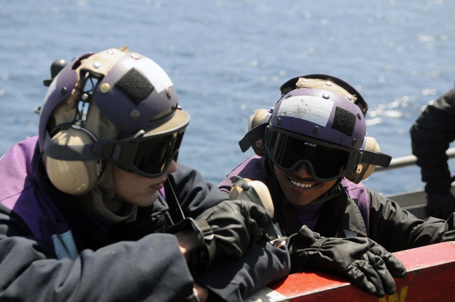 US Navy 090417-N-3610L-341 Aviation Boatswain's Mate (Fuels) Airman Christopher Levosky, left, and Aviation Boatswain's Mate (Fuels) Airman Jose Lopez stand by on a catwalk during flight operations aboard the aircraft carrier U