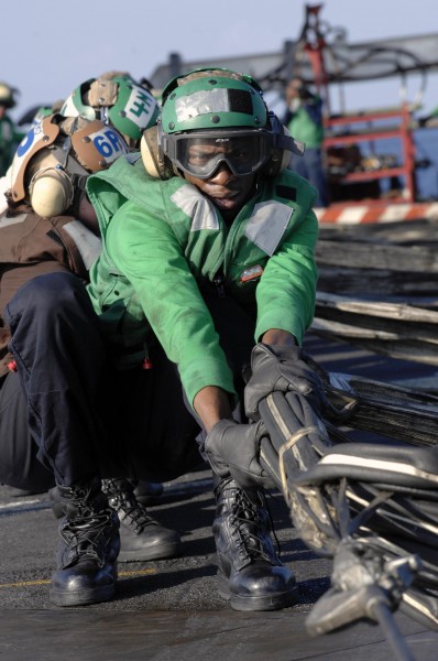 US Navy 090430-N-3702E-033 Aviation Boatswain's Mate (Equipment) Milton Holt from Air department, V-2 division, pulls on the webbing of the barricade 