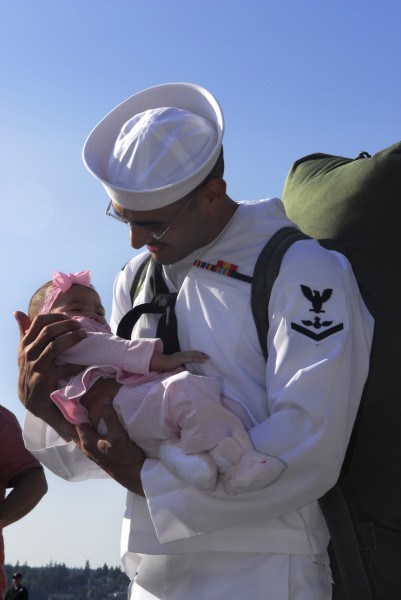 US Navy 090710-N-2475A-091 Aviation Ordnanceman 3rd Class Gilberto Arambul, from Brownsville, Texas, holds his three-and-a-half month-old daughter for the first time