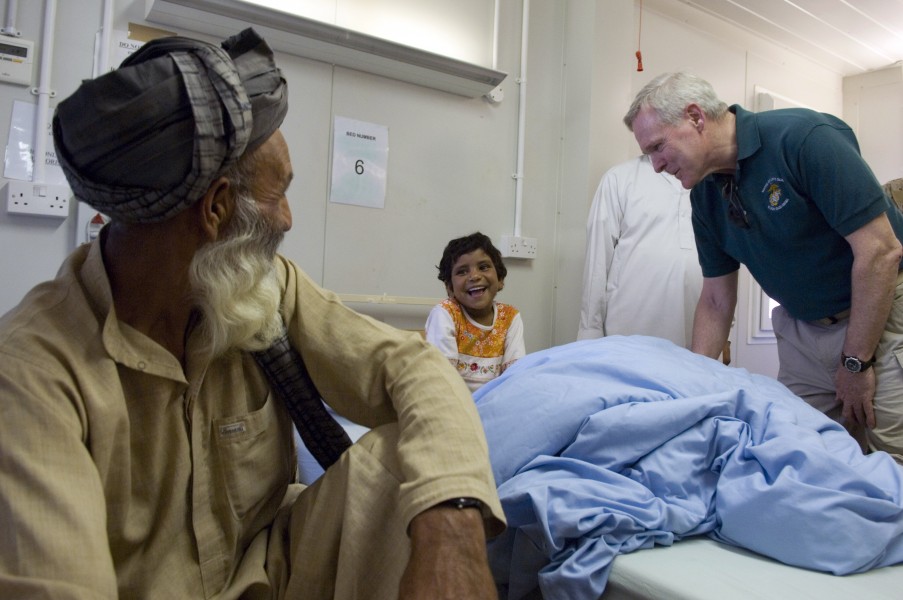 US Navy 090809-N-5549O-098 Secretary of the Navy (SECNAV) the Honorable Ray Mabus speaks to an Afghan girl while touring a hospital at Camp Bastion, Afghanistan