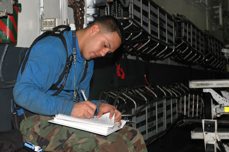 US Navy 090904-N-8960W-010 Aviation Boatswain's Mate Handling Airman Andres Garcia studies for a qualification exam in the hangar bay aboard the aircraft carrier USS Nimitz (CVN 68)