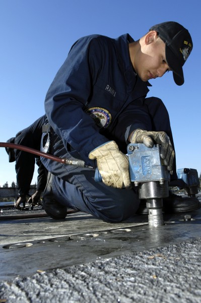 US Navy 091008-N-4954I-029 Aviation Boatswain's Mate (Equipment) Airman Alfred Ranili, from Hayward, Calif., tightens a retainer rail bolt on catapult three on the flight deck of the Nimitz-class aircraft carrier USS John C. St