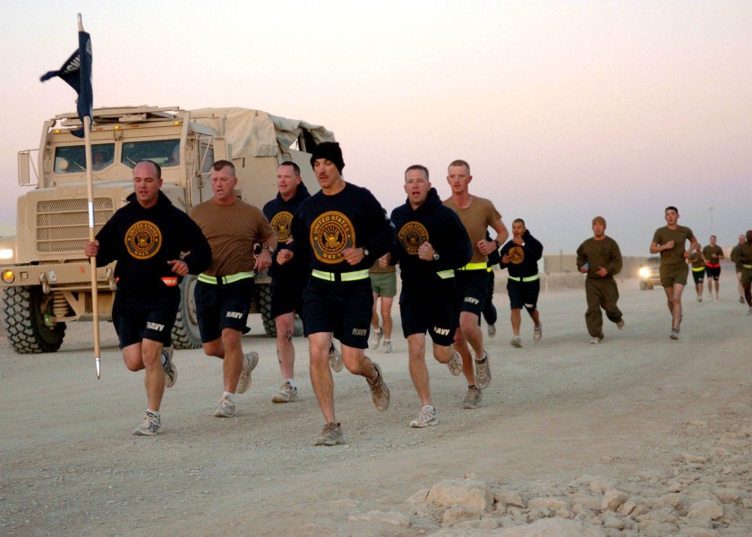 US Navy 091013-N-4440L-068 Seabees assigned to Alfa Company of Naval Mobile Construction Battalion (NMCB) 74 run with their company guidon during a 5-kilometer run at Camp Leatherneck, Afghanistan