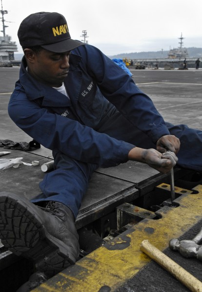 US Navy 091020-N-4954I-035 Aviation Boatswain's Mate (Equipment) Airman Recruit Ryann McKinney, from Portsmouth, Va., tightens a bolt