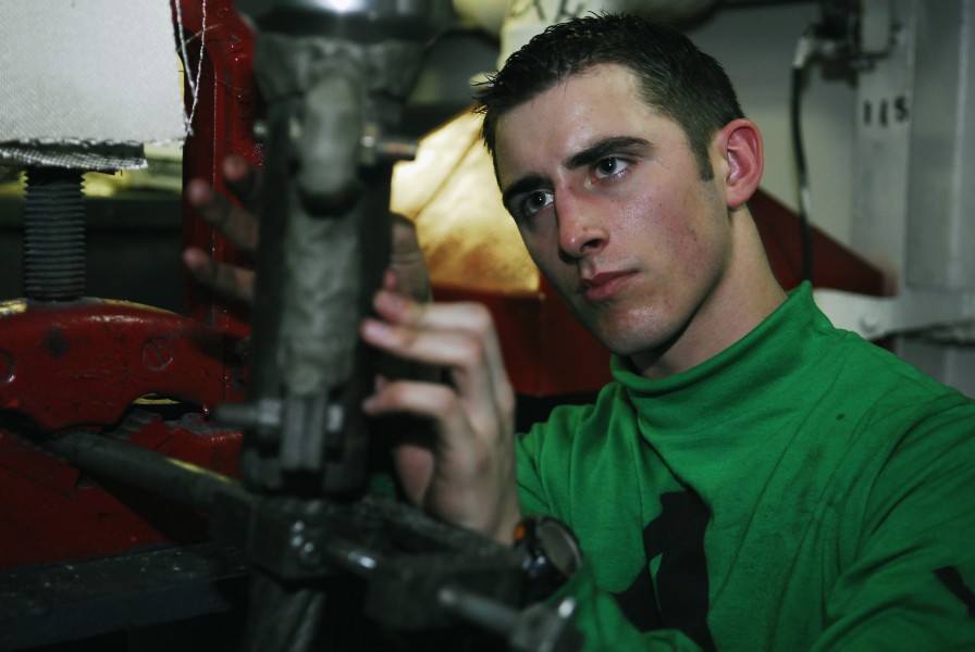 US Navy 100122-N-1194D-135 Aviation Boatswain's Mate (Equipment) 3rd Class Andrew Sallee packs fire retardant material
