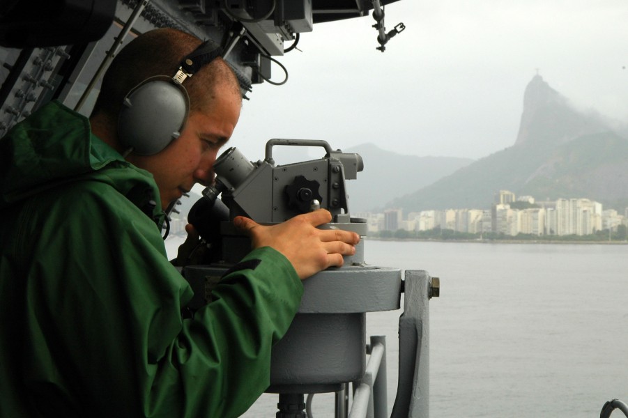US Navy 100226-N-8822R-235 Quartermaster 3rd Class Daniel Gastaldi measures the distance of checkpoints as the aircraft carrier USS Carl Vinson (CVN 70) prepares to anchor off the coast of Rio de Janeiro, Brazil